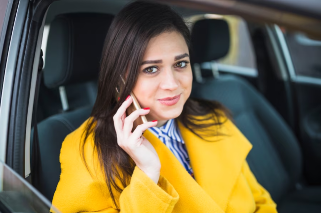 Apex Cars Bracknell lady sitting in a taxi while on the phone